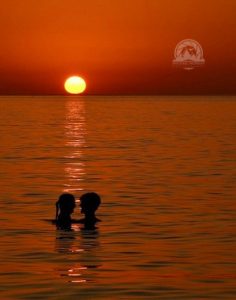 I sat on a breakwall to take in the sunset at Huntington Beach in Bay Village. A young couple accented the scene.