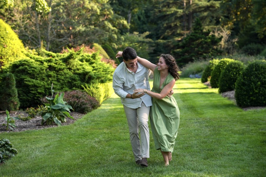 Engaged couple lovingly walking together along a garden path during an proposal photography session in Ohio.