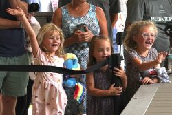 Children react as a mother is baptized outside. Children react as a mother is baptized outside.